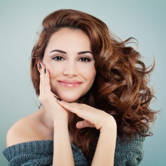 Beautiful Smiling Woman with Wavy Hairstyle.
