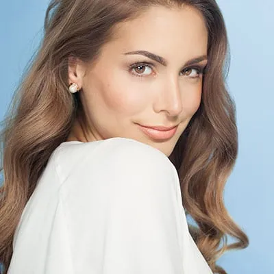 home-services-botox Woman smiling while looking over her shoulder.